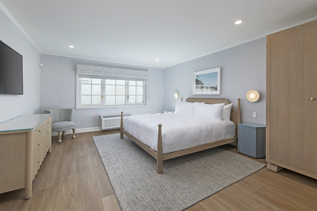 a bedroom with a bed and a chair