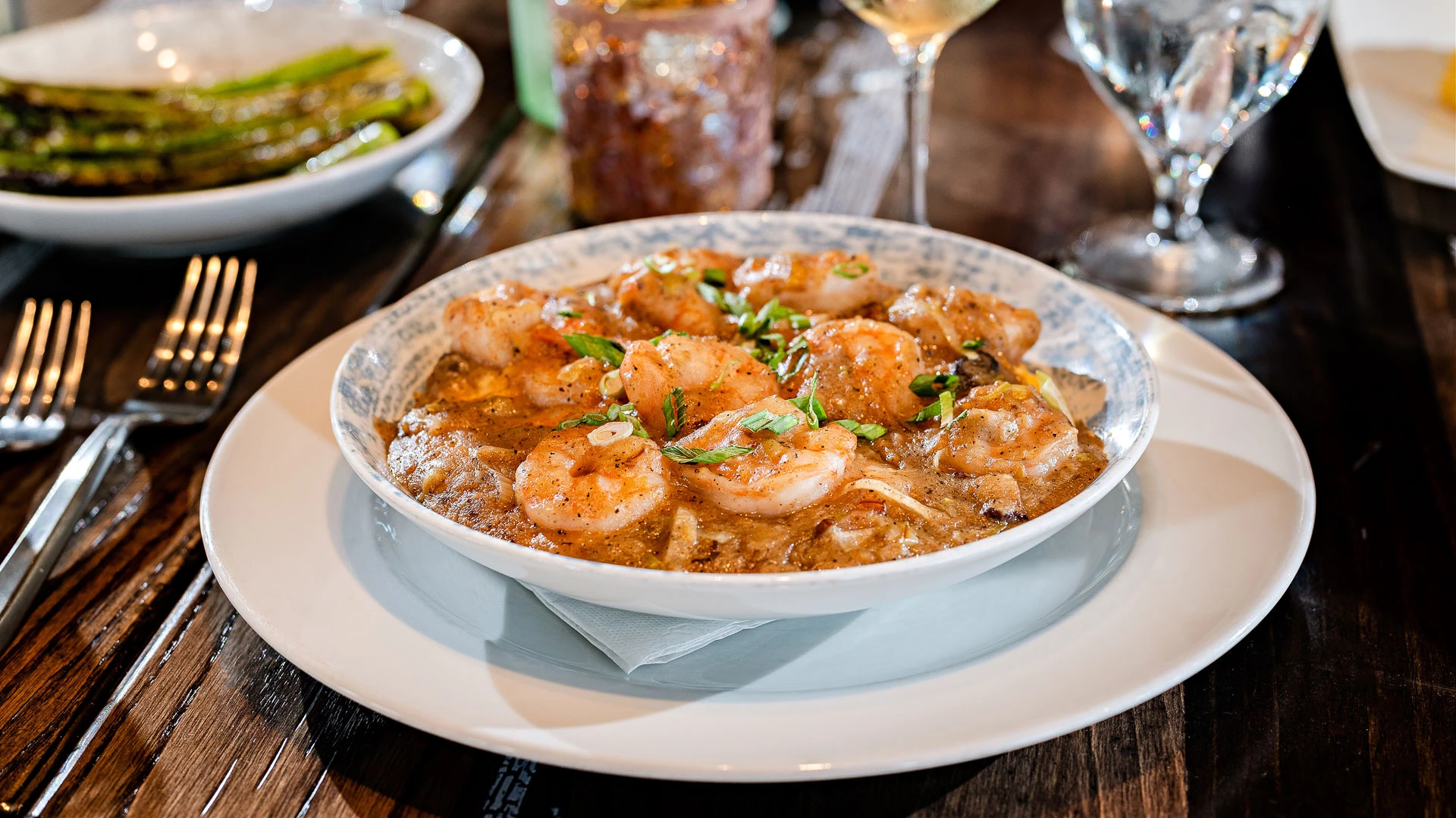 a bowl of shrimp and sauce on a plate