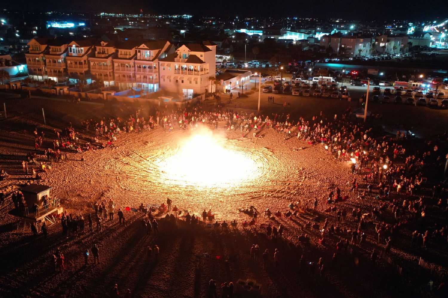 a large group of people around a fire