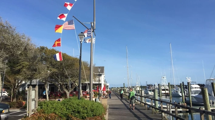 a group of people walking on a dock