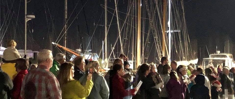 a group of people standing on a dock