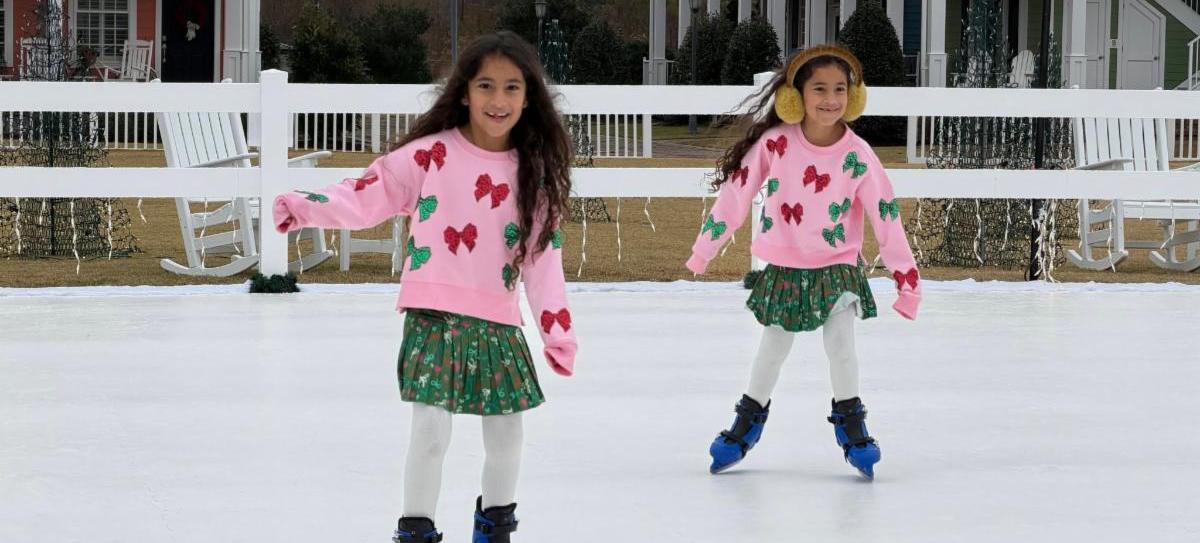 two girls wearing matching outfits