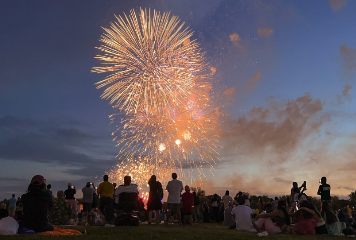 a group of people watching fireworks