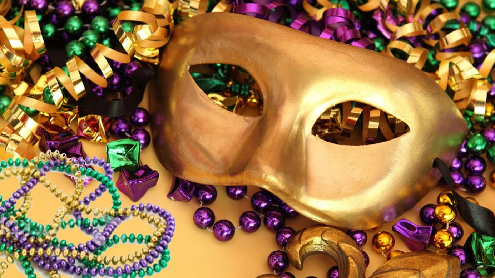 a gold mask with beads and streamers