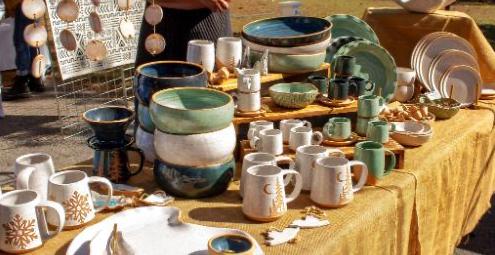 a table with various dishes and mugs