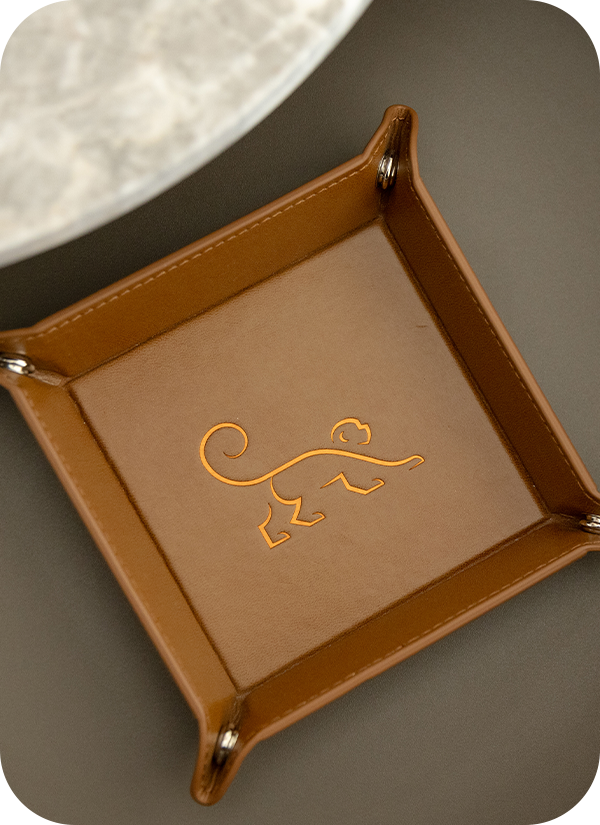 a brown square object with a monkey logo on it