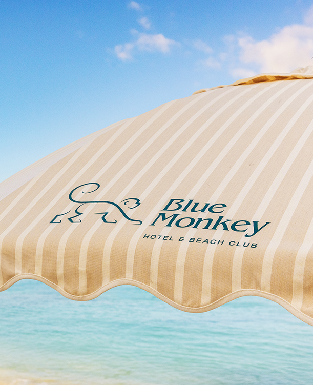 a striped umbrella with a logo on it