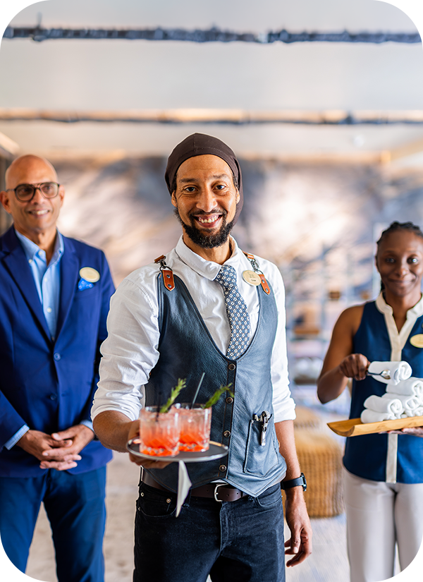 a group of people standing in front of a tray of drinks