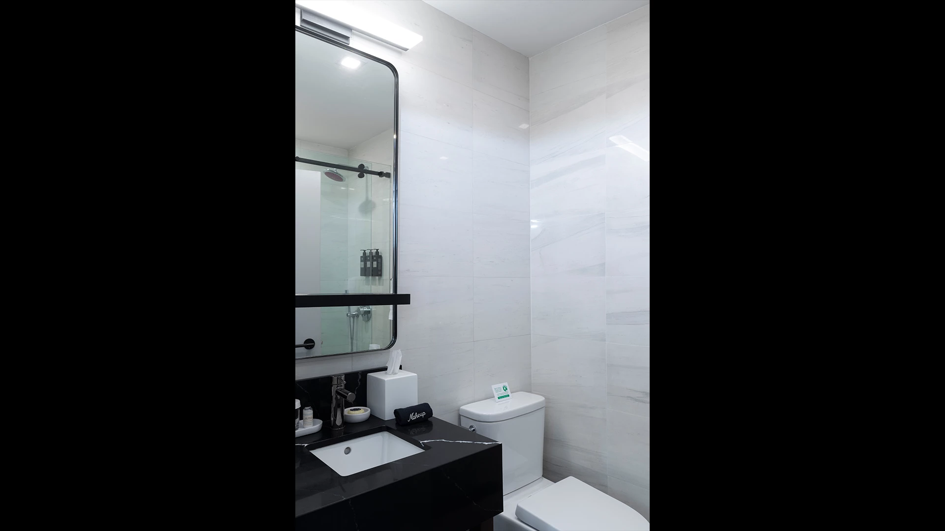A clean bathroom with a sink, toilet, and shower