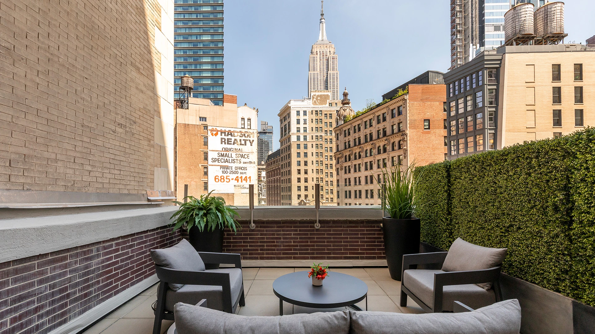 A rooftop patio with a view of the city skyline