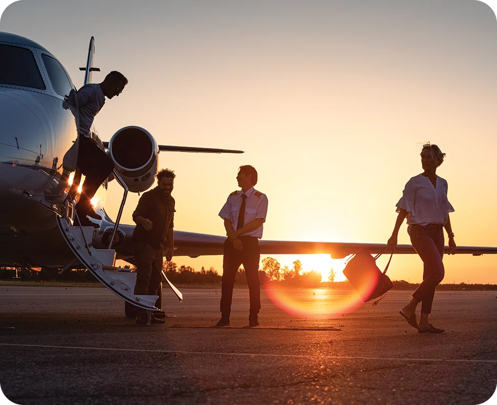 a group of people standing next to a plane