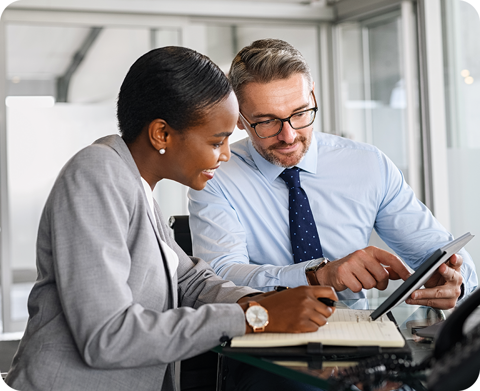 a man and woman looking at a tablet