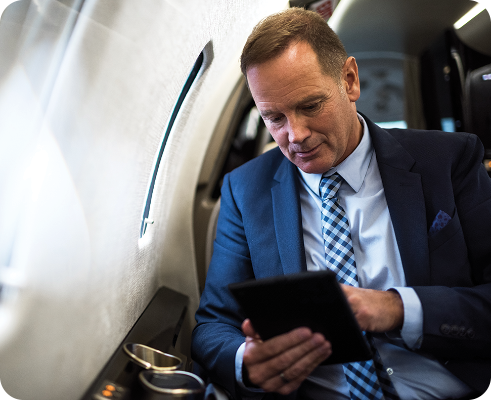 a man in a suit and tie looking at a tablet