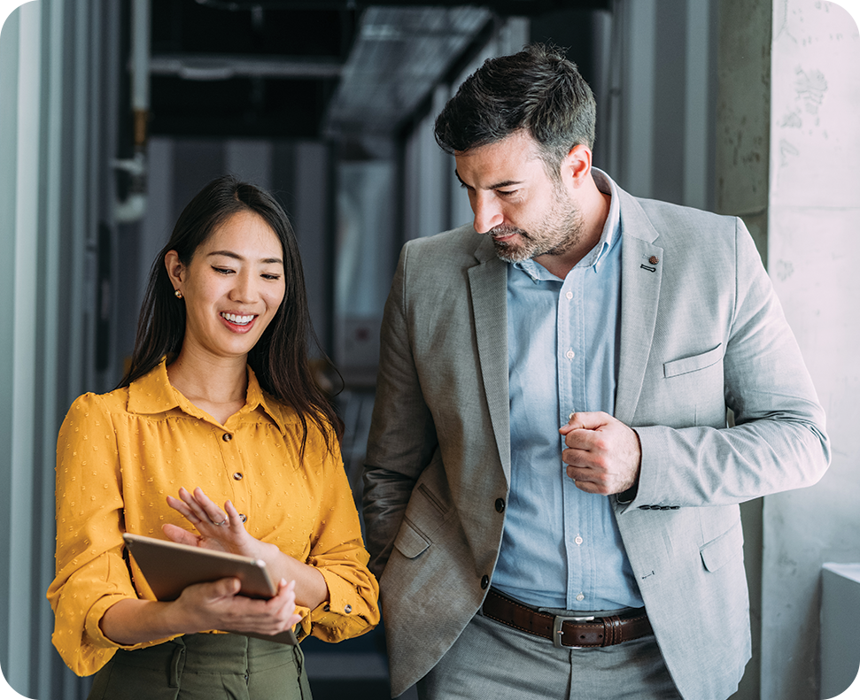 a man and woman looking at a tablet
