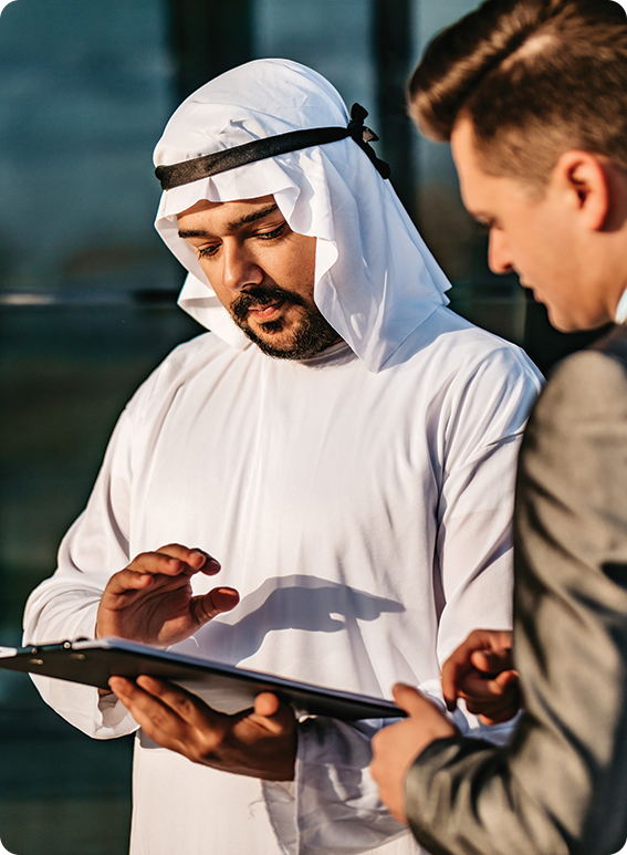 a man in a white robe looking at a clipboard