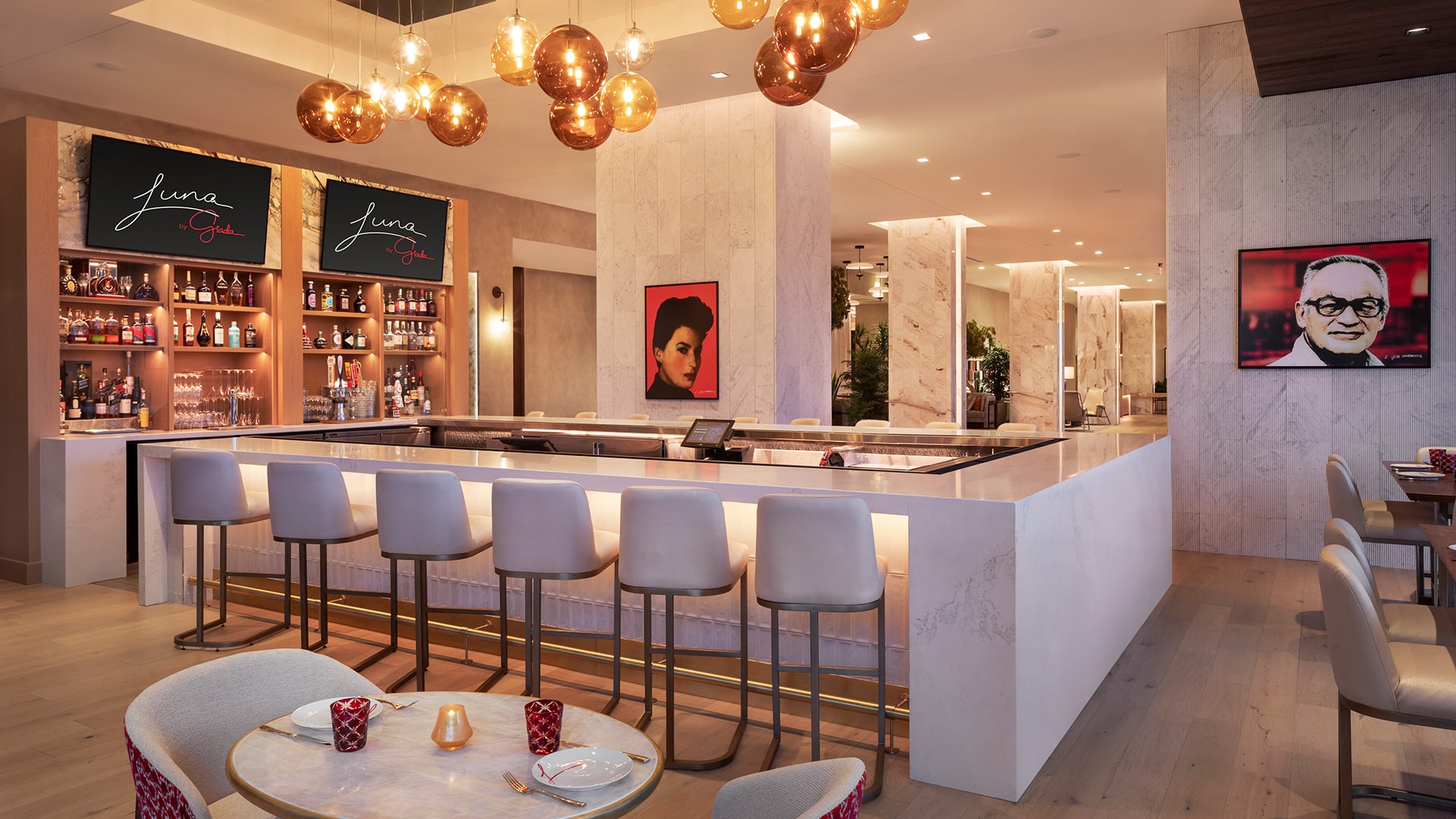 a bar with chairs and a table with a picture of a woman