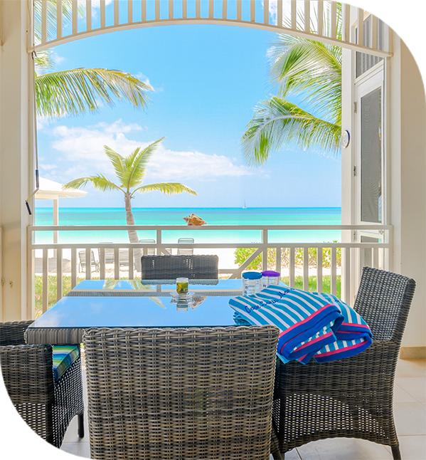 a table and chairs on a patio overlooking a beach