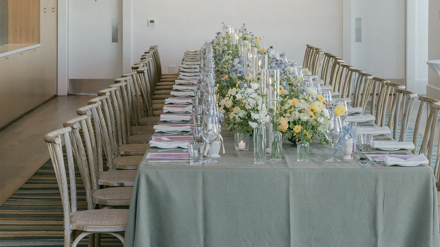 a long table with flowers and candles