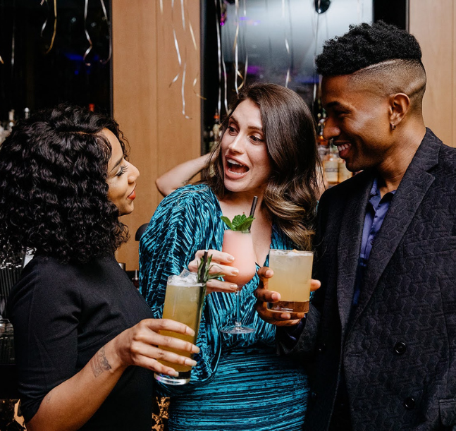 a group of people holding drinks
