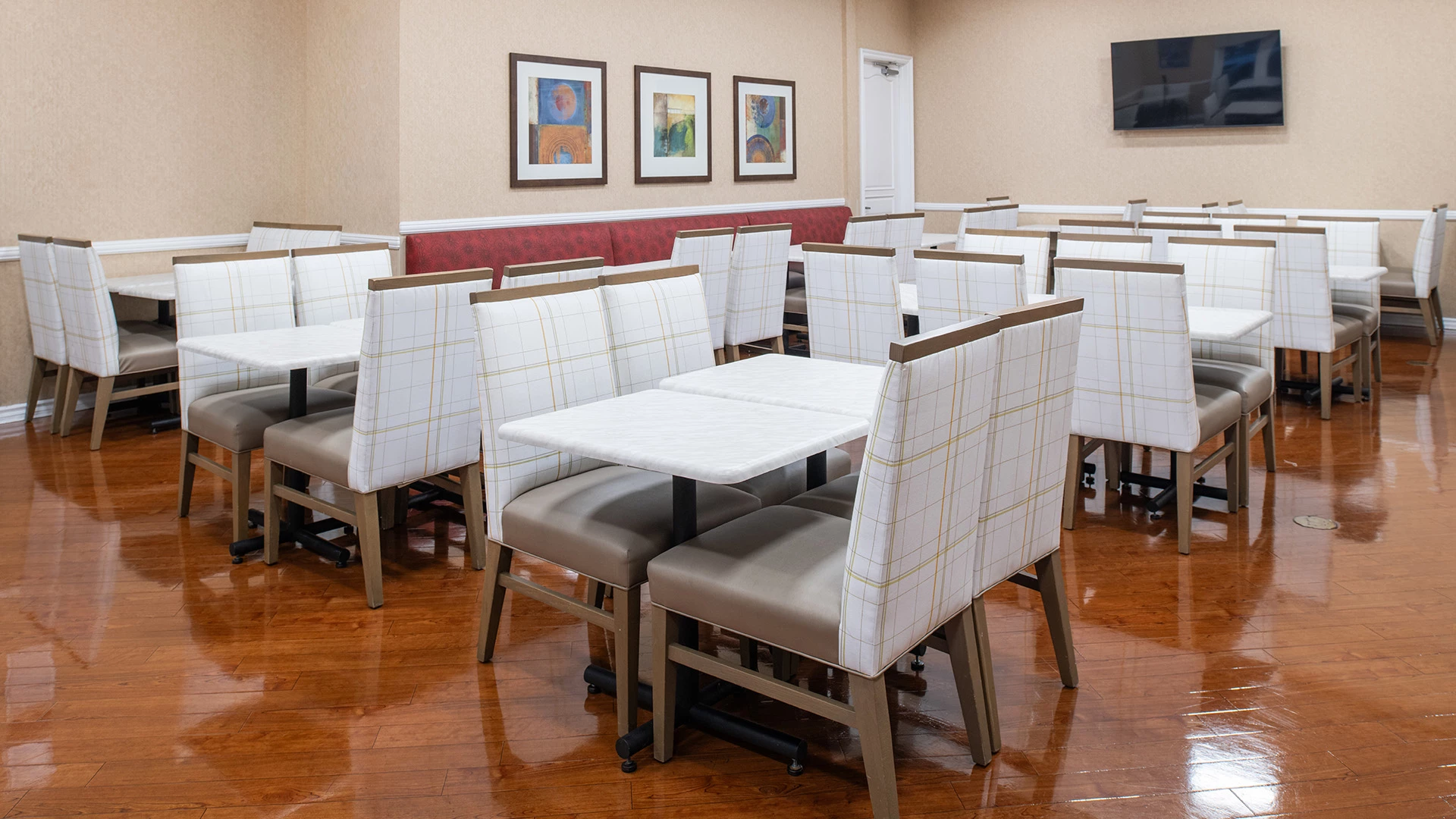 a dining area with white tables and chairs