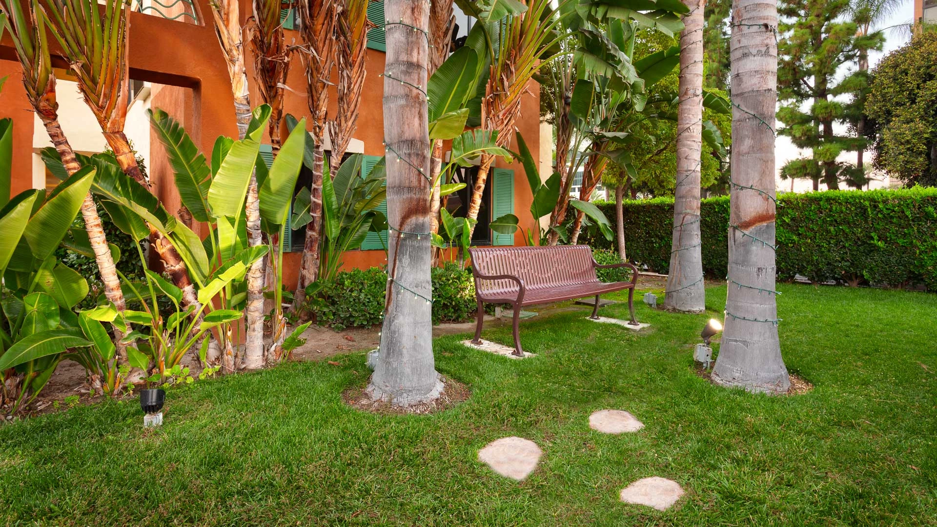 a small outdoor seating area with a bench and trees