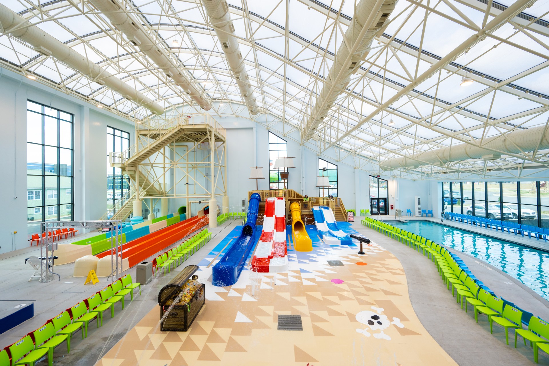 a swimming pool with a slide and a ball in it