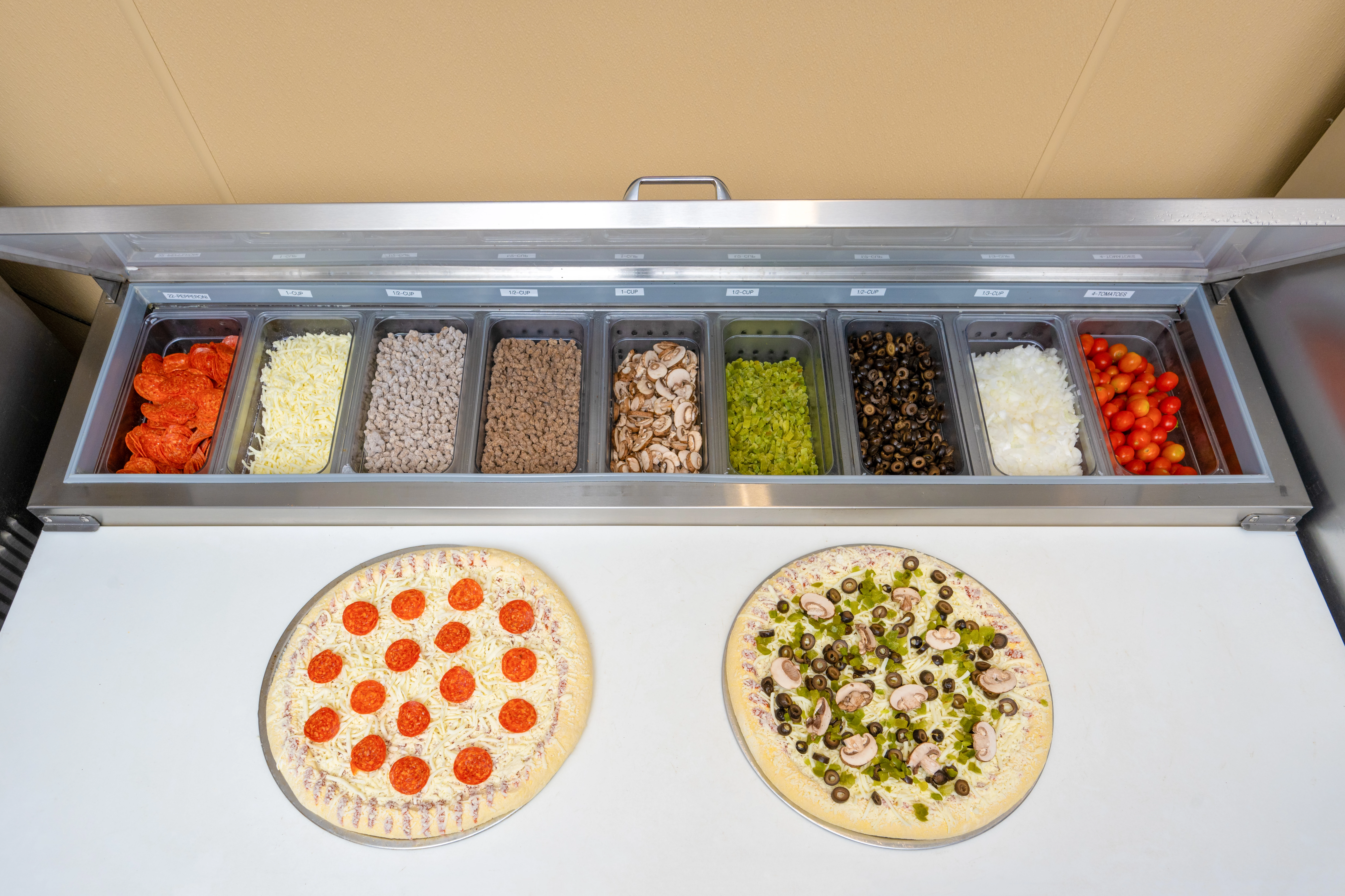 a pizzas and other food items in a container