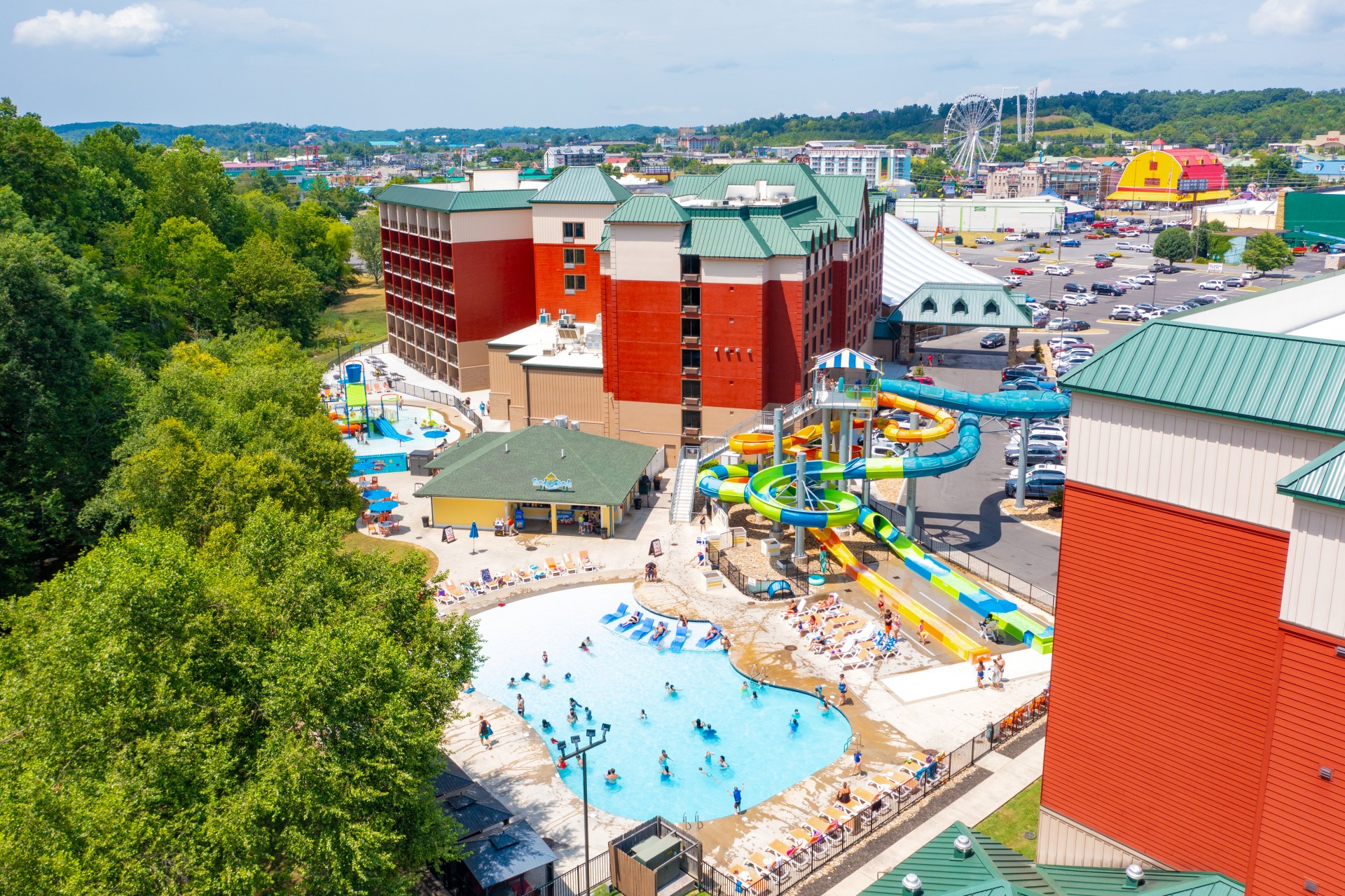 a water park with a water slide and people swimming in it