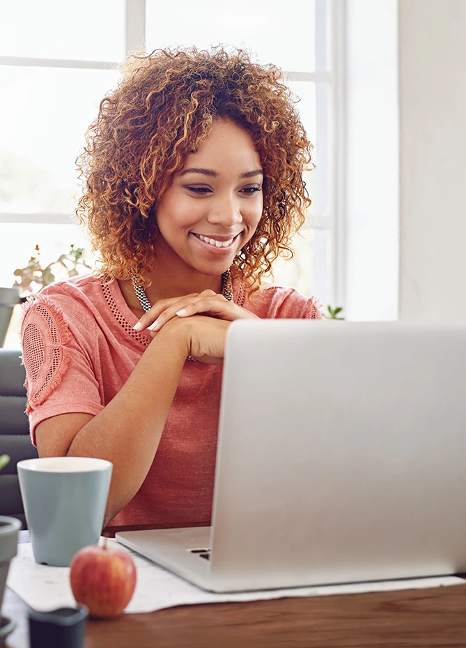 a woman looking at a laptop