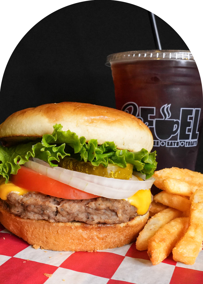 a burger and fries with a drink in the background