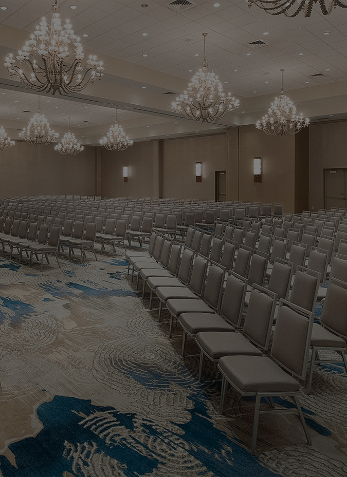 a large room with chairs and chandeliers