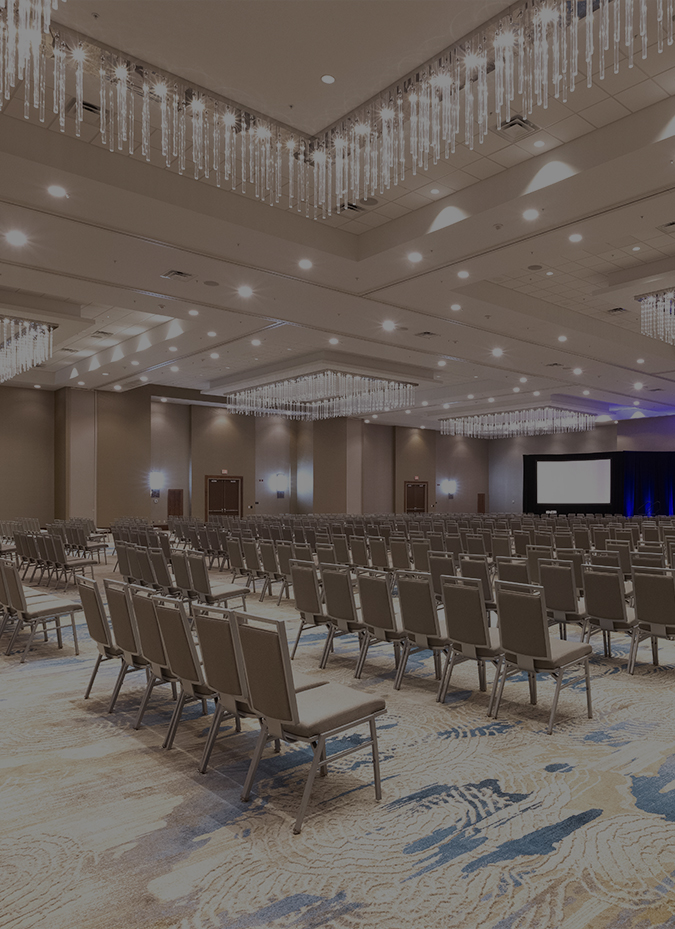 a large room with chairs and chandeliers