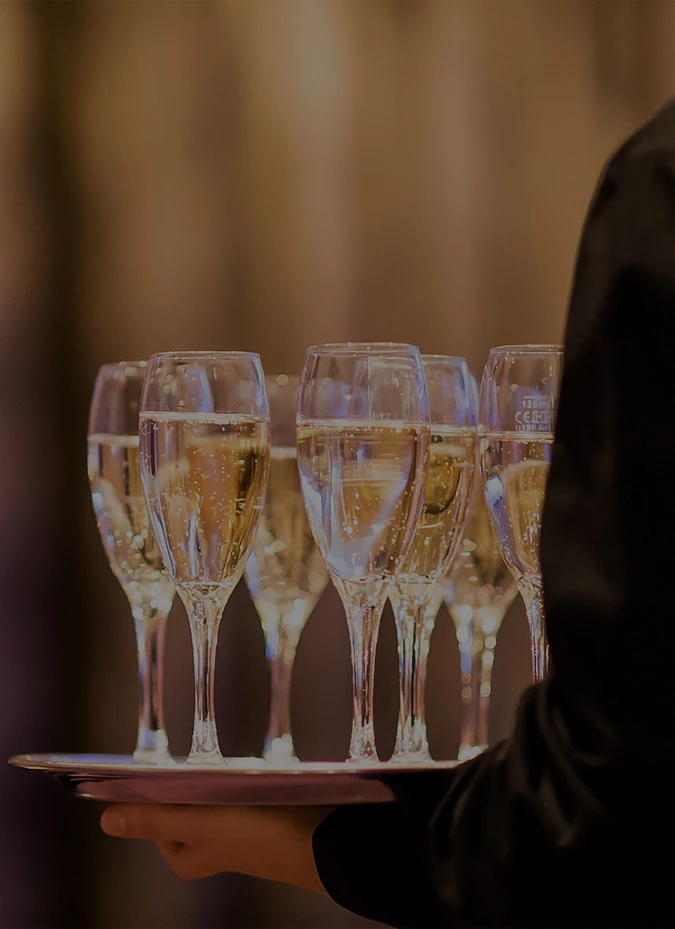 a group of champagne glasses on a tray