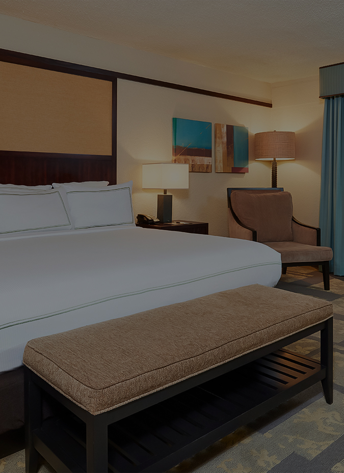a bedroom with a bed and a bench