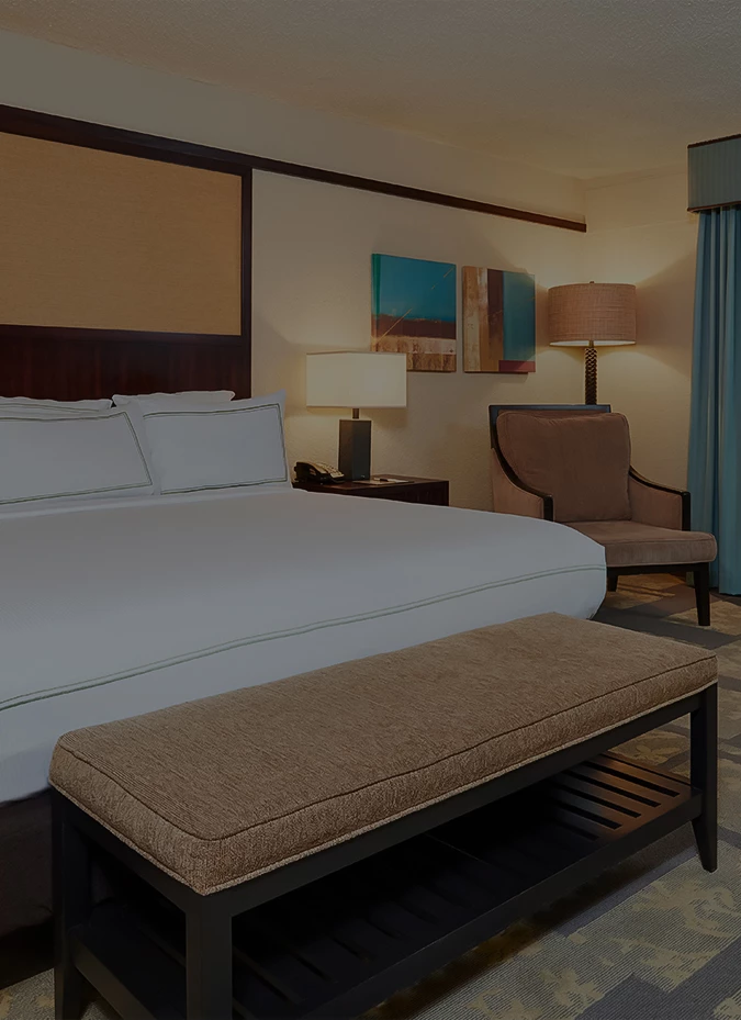 a bedroom with a bed and a bench