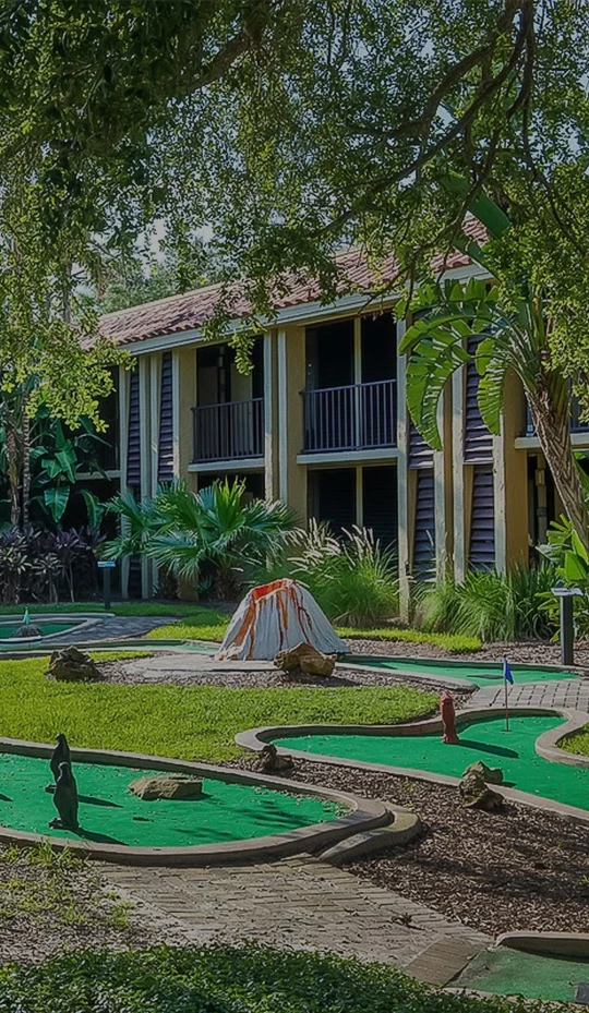 a mini golf course with a building in the background