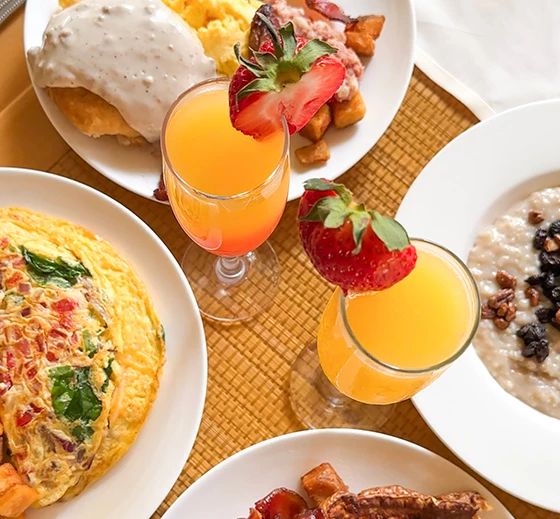 a table with plates of food and drinks