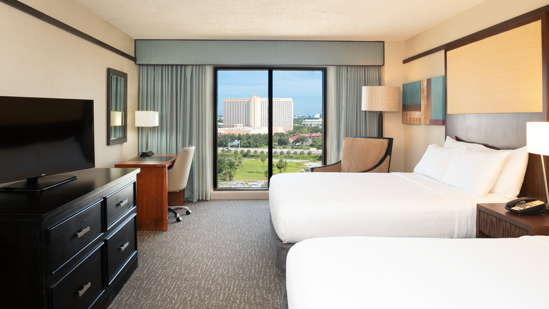 a room with two beds and a desk