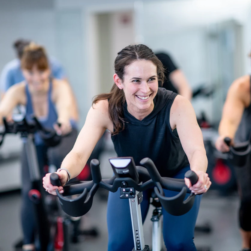 a group of women on exercise bikes