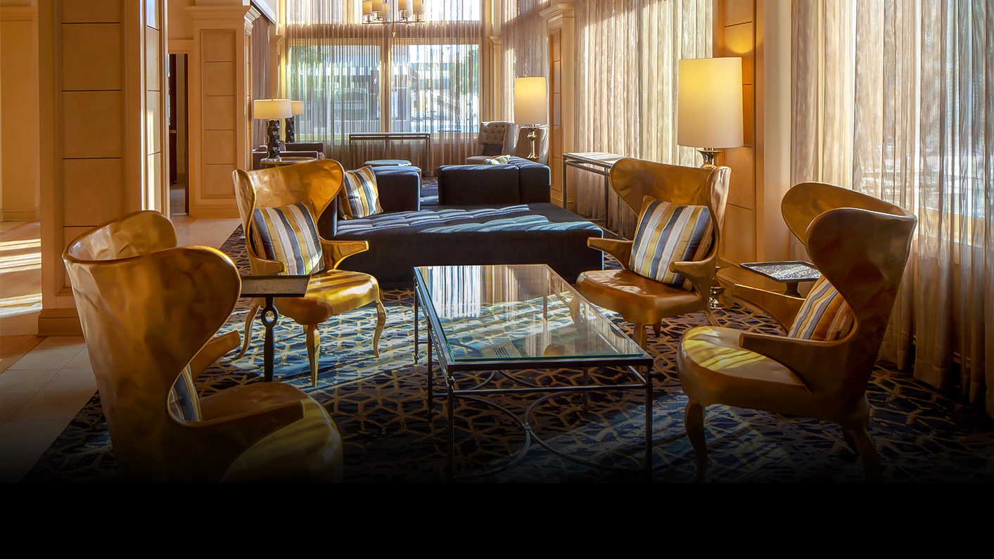 a room with a couch and chairs