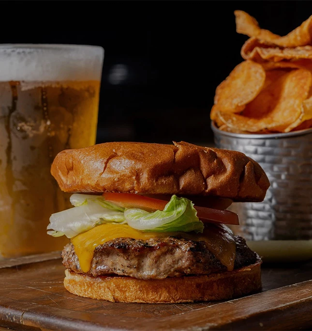 a burger and potato chips on a table