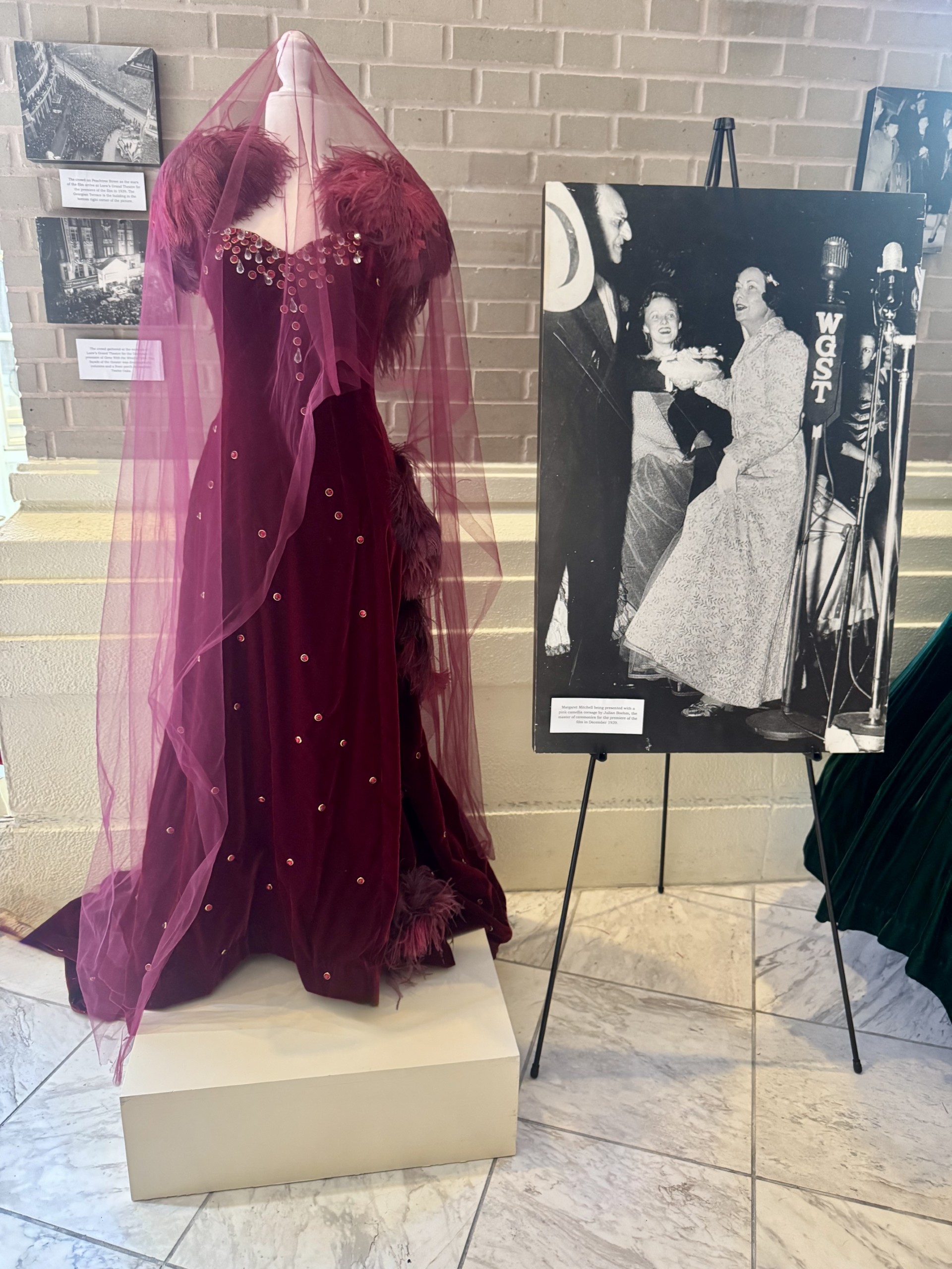 a mannequin with a dress and a picture of a couple of women