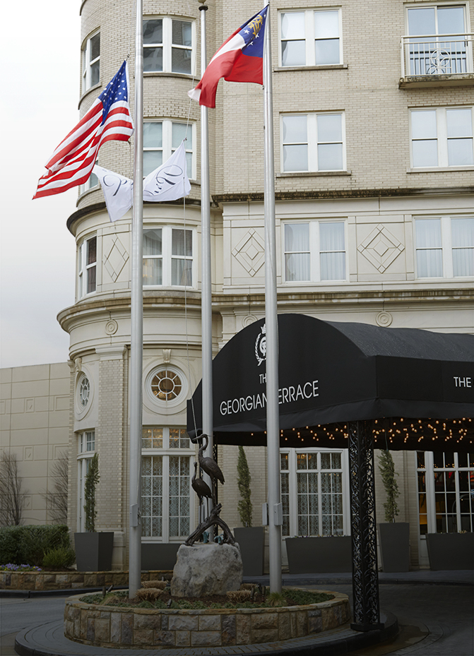 flags on poles in front of a building