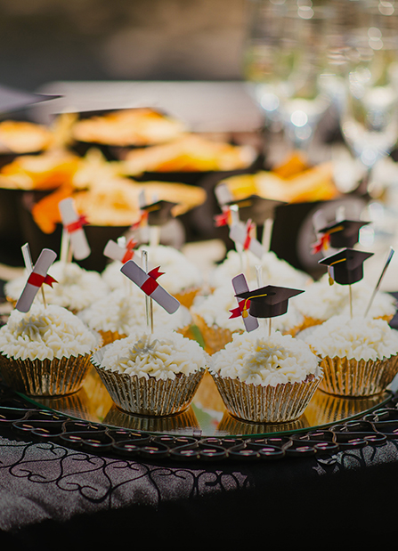 a group of cupcakes with graduation caps on top