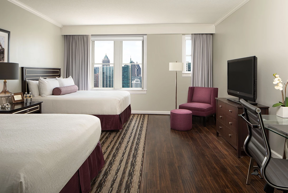 a hotel room with two beds and a television
