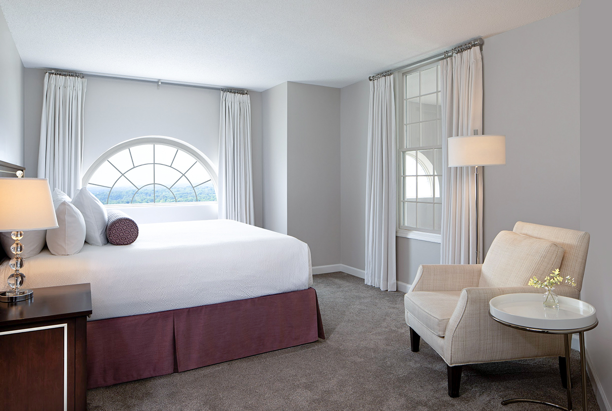 a bedroom with a bed and a chair