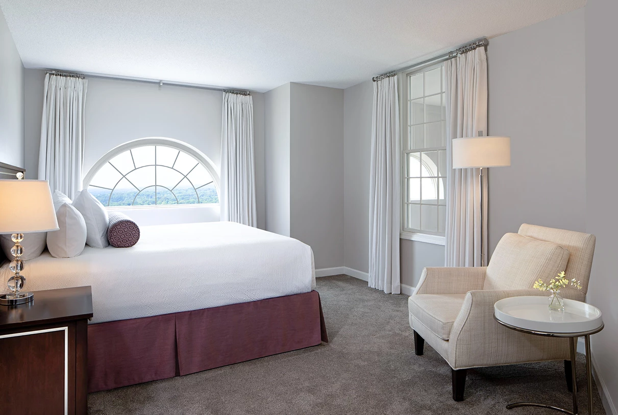 a bedroom with a bed and a chair