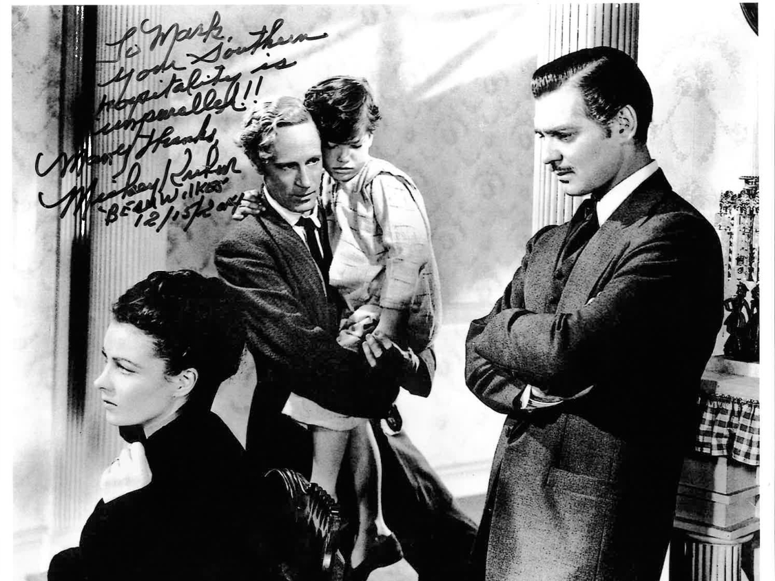 a man and a child standing next to a man and a woman