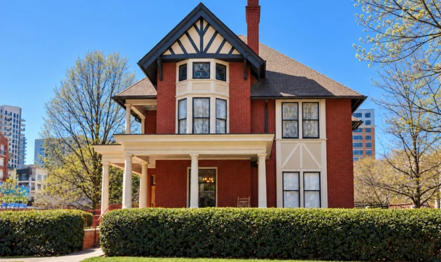 A red brick building with white trim and a gabled roof