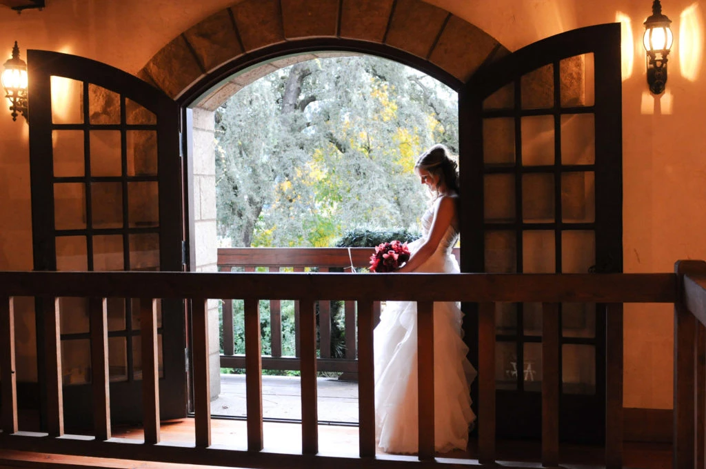 a woman in a wedding dress holding a bouquet of flowers